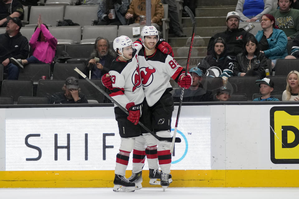 New Jersey Devils defenseman Kevin Bahl, right, celebrates after scoring a goal against the San Jose Sharks with center Nico Hischier during the second period of an NHL hockey game in San Jose, Calif., Tuesday, Feb. 27, 2024. (AP Photo/Jeff Chiu)