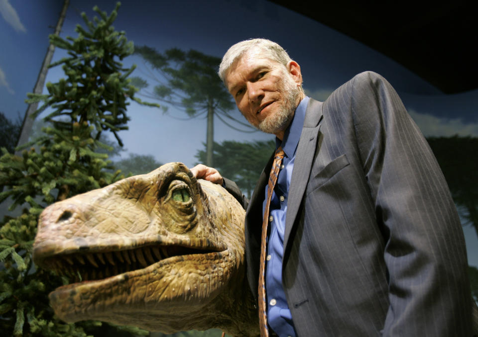 FILE - In this May 24, 2007 file photo, Ken Ham, founder of the nonprofit ministry Answers in Genesis, poses with one of his favorite animatronic dinosaurs during a tour of the Creation Museum in Petersburg, Ky. Ham, who recently debated evolution with TV's "Science Guy" Bill Nye, says fundraising after the widely watched event helped to revive stalled plans to build a 510-foot replica of Noah's Ark. (AP Photo/Ed Reinke, File)