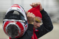Team Penske driver Will Power, of Australia, pulls off his helmet after morning warmups for the IndyCar season finale auto race at Laguna Seca Raceway on Sunday, Sept. 11, 2022, Monterey, Calif. (AP Photo/Nic Coury)