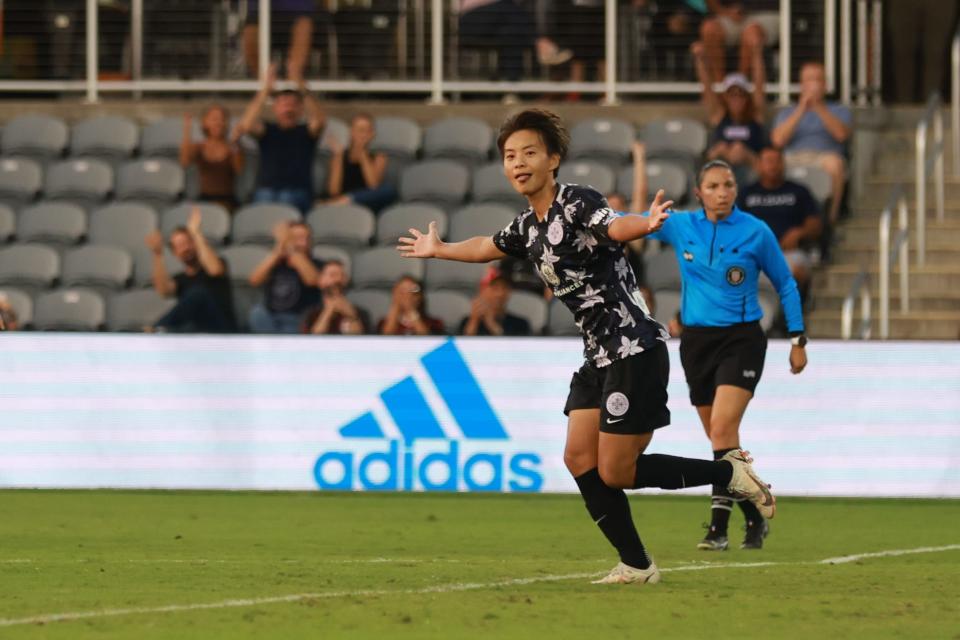 Racing Louisville FC forward Wang Shuang (77) celebrates a goal against AC Milan in a Women's Cup semifinal match at Lynn Family Stadium.