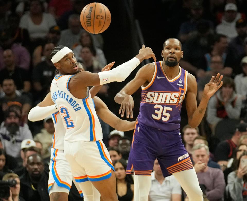 Phoenix Suns forward Kevin Durant (35) passes the ball against Oklahoma City Thunder guard Shai Gilgeous-Alexander (2) during the first quarter at Footprint Center in Phoenix on March 3, 2024.