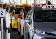 Toyota Prius cars used as taxis are lined-up awaiting arriving passengers at San Diego International Airport in San Diego, California, U.S. on April 4, 2016. REUTERS/Mike Blake/File Photo