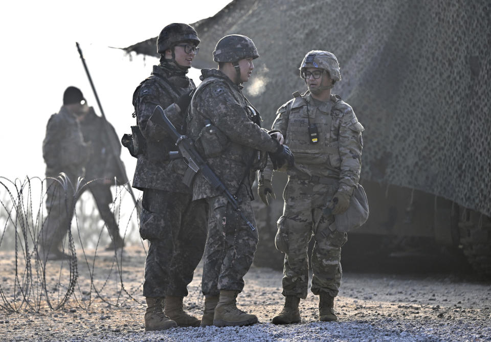South Korean soldiers talk with a US soldier, right, during their joint live fire exercise at a military training field in Pocheon, South Korea Thursday, March 14, 2024 as part of the annual Freedom Shield joint military exercise between South Korea and the United States. (Jung Yeon-je/Pool Photo via AP)