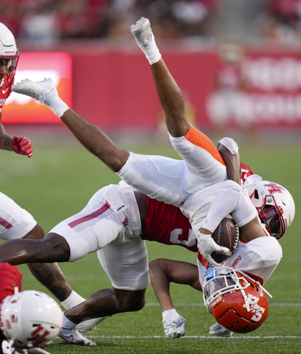 Sam Houston State kick returner Malik Phillips, right, is tackled by Houston's Hasaan Hypolite during the first half of an NCAA college football game, Saturday, Sept. 23, 2023, in Houston. (AP Photo/Eric Christian Smith)