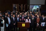 President of the Legislative Council Andrew Leung, center, and lawmakers attend a press conference following the passing of the Basic Law Article 23 legislation at the Legislative Council in Hong Kong, Tuesday, March 19, 2024. Hong Kong lawmakers unanimously approved a new national security law on Tuesday that grants the government more power to quash dissent, widely seen as the latest step in a sweeping political crackdown that was triggered by pro-democracy protests in 2019. (AP Photo/Louise Delmotte)