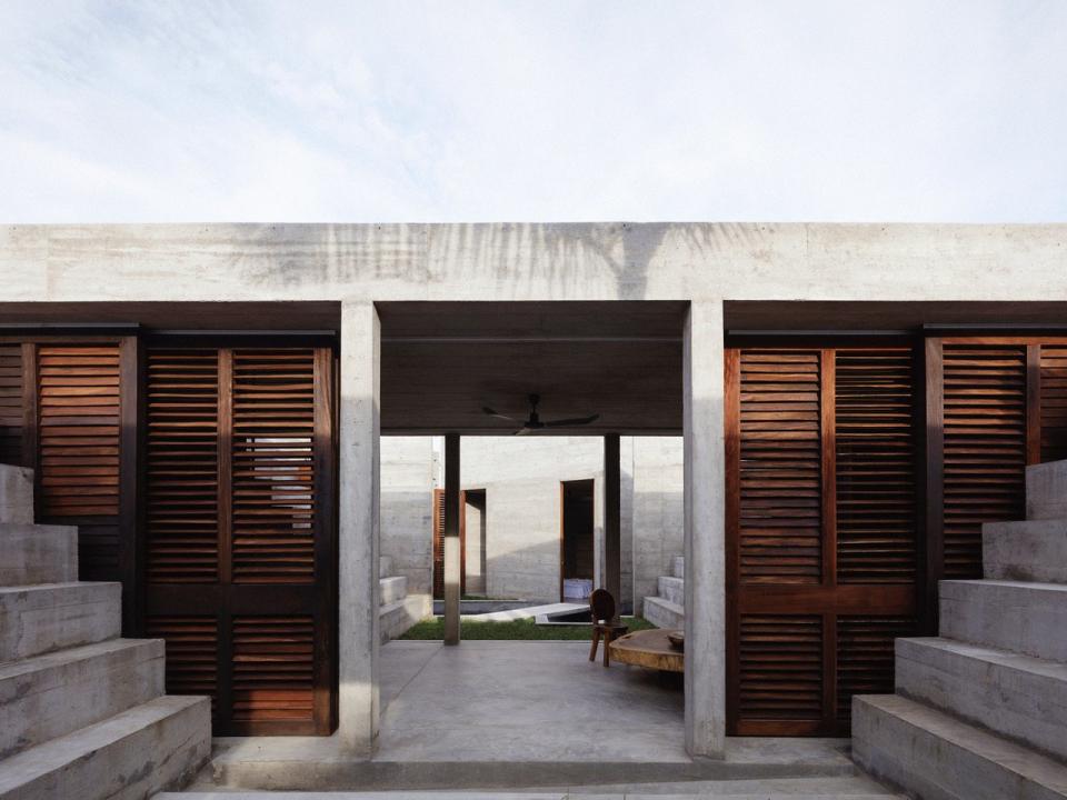 Timber shutters and wide open doorways keep the otherwise-cold feeling Zicatela House connected to nature at all times. 