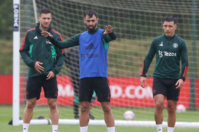 Diogo Dalot, Bruno Fernandes, Lisandro Martinez of Manchester United in action during a first team training session at Carrington Training Ground on May 22, 2024