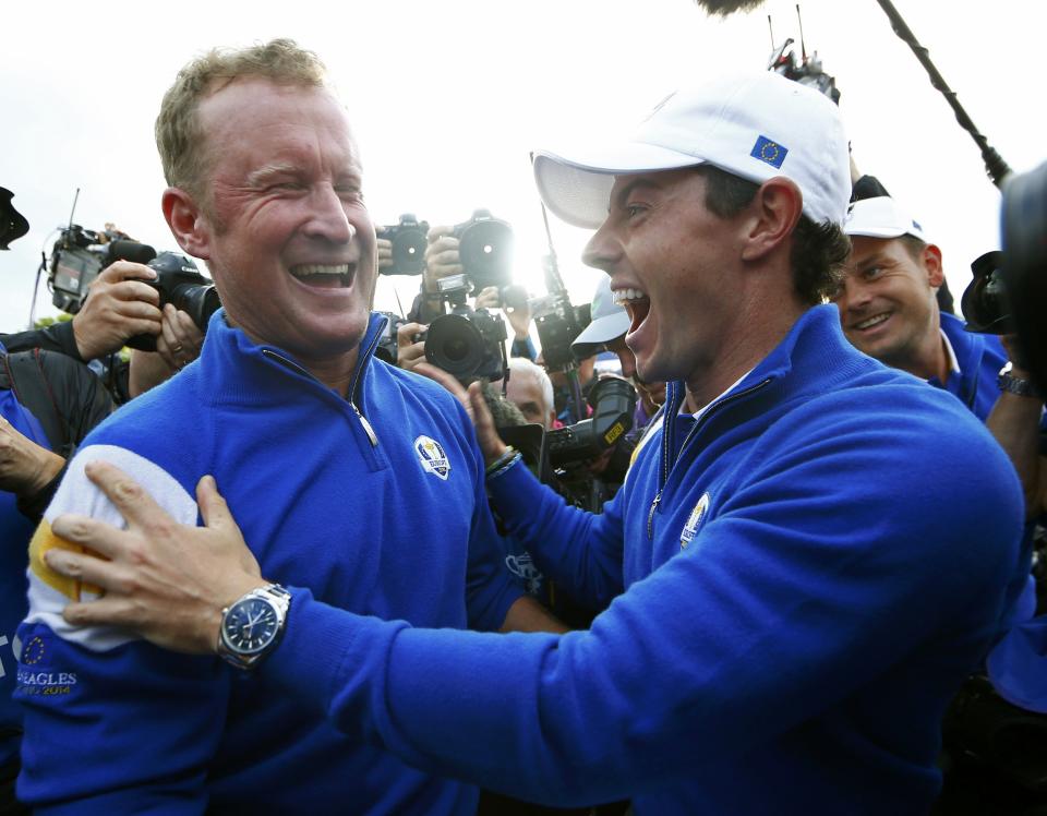 Team Europe golfer Jamie Donaldson (L) celebrates with teammate Rory McIlroy after winning his match against U.S. player Keegan Bradley to retain the Ryder Cup for Europe on the 15th green during the 40th Ryder Cup at Gleneagles in Scotland September 28, 2014. REUTERS/Eddie Keogh (BRITAIN - Tags: SPORT GOLF TPX IMAGES OF THE DAY)