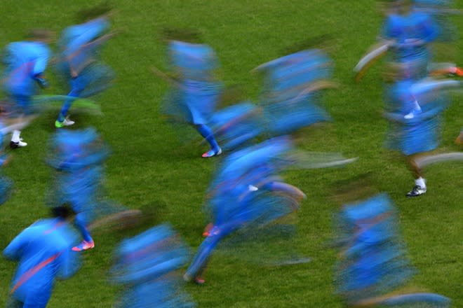 TOPSHOTS Dutch players are seen with a slow speed exposure on May 18, 2012 in Lausanne during a training session ahead of the Euro 2012. The Netherlands national football has a training camp in Switzerland. TOPSHOTS/AFP PHOTO / FABRICE COFFRINIFABRICE COFFRINI/AFP/GettyImages