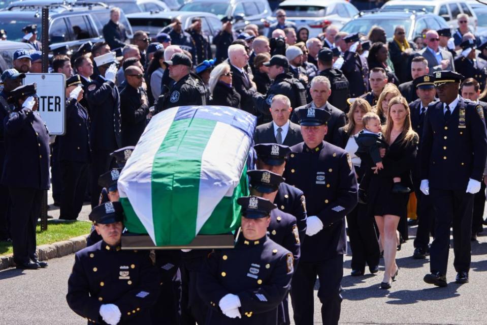 Diller’s casket is carried at his funeral, with wife Stephanie and son Ryan behind it. James Keivom