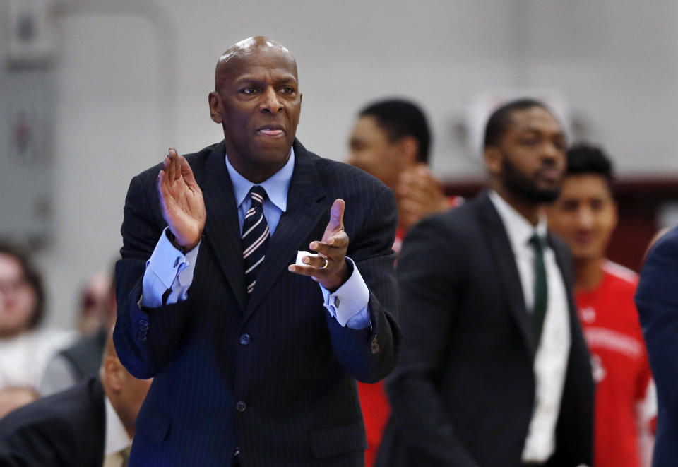 Boston University's head coach Joe Jones cheers from the bench in the second half of the NCAA Patriot League Conference basketball championship against Colgate at Cotterell Court, Wednesday, March 11, 2020, in Hamilton, N.Y. (AP Photo/John Munson)