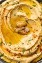 <p>Hummus is a Middle Eastern dish made of chickpeas and tahini. We love adding plenty of garlic or roasted red peppers and other spices (like <a href="https://www.delish.com/cooking/a36622721/everything-bagel-seasoning/" rel="nofollow noopener" target="_blank" data-ylk="slk:everything bagel seasoning" class="link ">everything bagel seasoning</a>) for added flavor. Carrots and cucumber spears make a crisp, refreshing snack, especially when you pair them with a dip that can withstand the heat, like hummus.<br><br>Get the <strong><a href="https://www.delish.com/cooking/recipe-ideas/a20089167/best-homemade-hummus-recipe/" rel="nofollow noopener" target="_blank" data-ylk="slk:Creamy Garlic Hummus recipe" class="link ">Creamy Garlic Hummus recipe</a></strong>.</p>