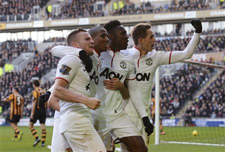 Manchester United players (L-R) Tom Cleverley, Ashley Young, Danny Welbeck and Adnan Januzaj celebrate an own goal by Hull City's James Chester (not pictured) during their English Premier League soccer match at the KC Stadium in Hull, northern England December 26, 2013. REUTERS/Nigel Roddis