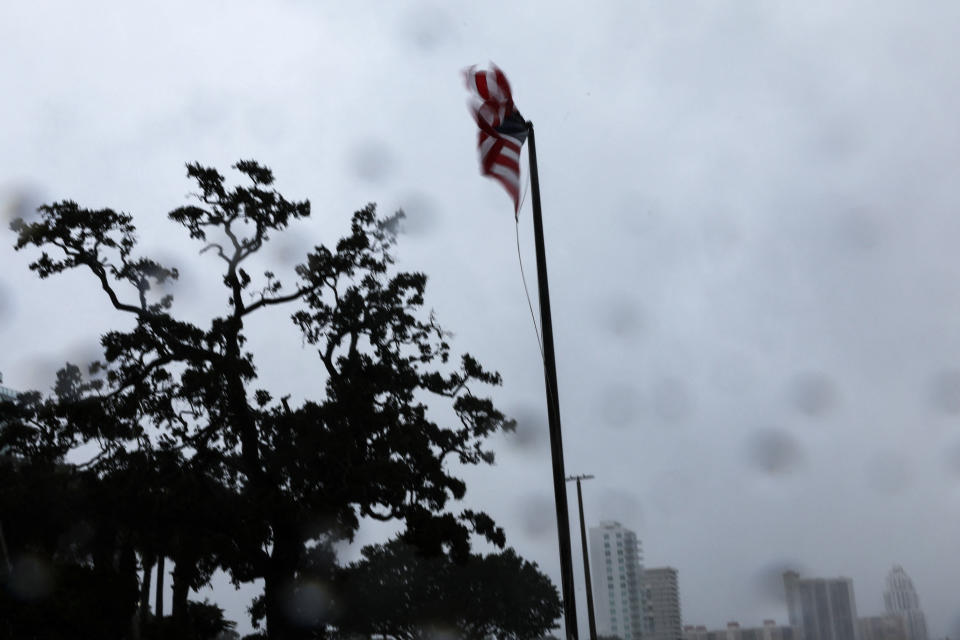 A U.S. flag blows in the wind as Hurricane Ian makes landfall in southwestern Florida, in Tampa, Florida, U.S., September 28, 2022. REUTERS/Shannon Stapleton