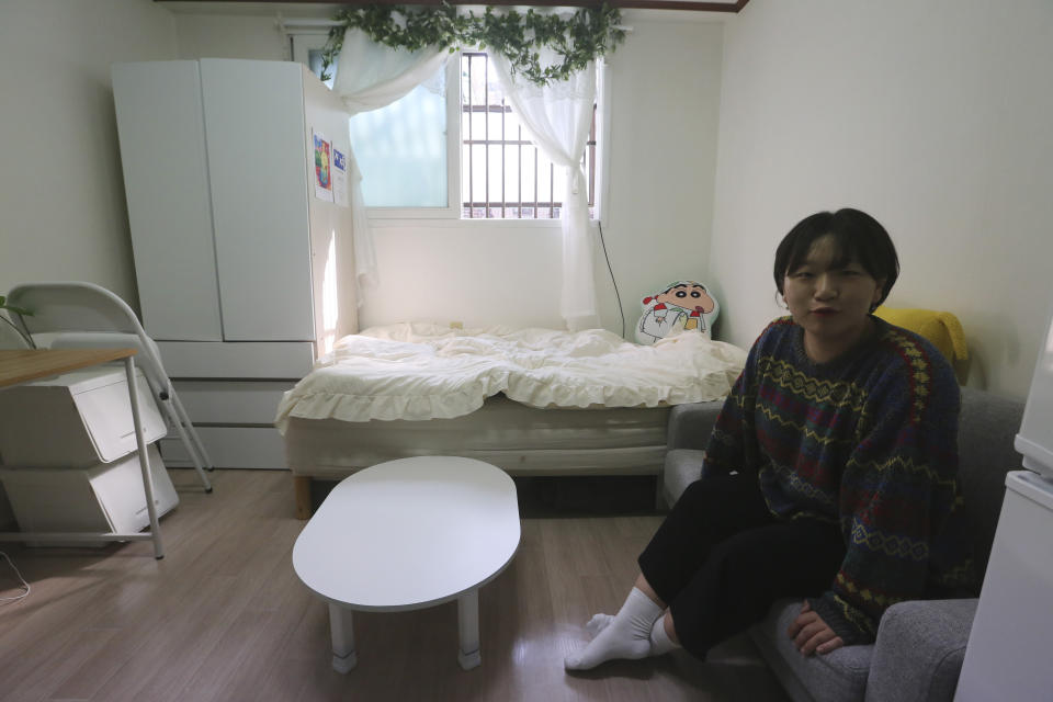 Kim Da-hye, a 29-year-old South Korean, sits in her semi-basement apartment in Seoul, South Korea, Saturday, Feb. 15, 2020. For many South Koreans, the image of a cramped basement apartment portrayed in the Oscar-winning film “Parasite” rings true, bringing differences in their social status to worldwide attention.(AP Photo/Ahn Young-joon)