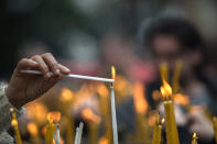 <p>Orthodox Christians light candles in the garden of St. Kliment’s church on Good Friday, in Skopje, the former Yugoslav republic of Macedonia, April 29, 2016. <i>(Georgi Licovski/EPA)</i></p>