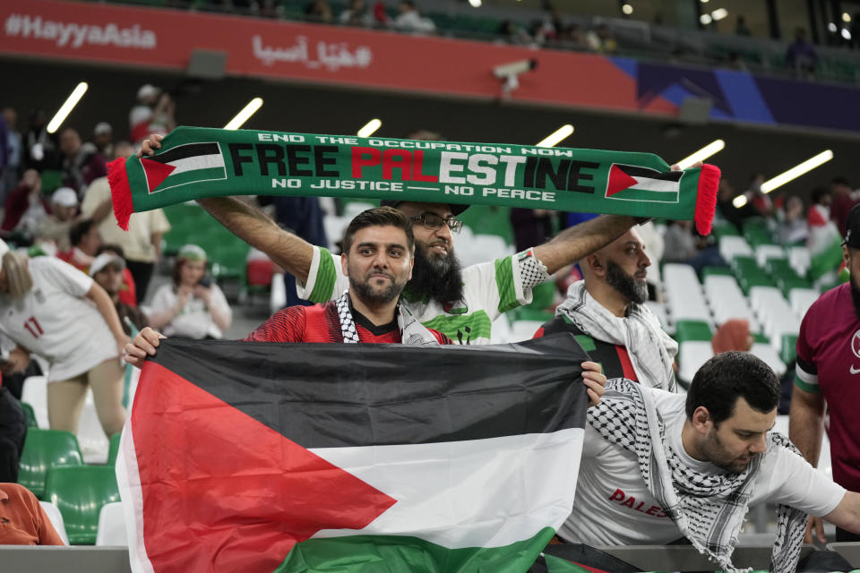 Supporters of Palestine wait for the start of the Asian Cup Group C soccer match between Iran and Palestine at the Education City Stadium in Al Rayyan, Qatar, Sunday, Jan. 14, 2024. (AP Photo/Aijaz Rahi)