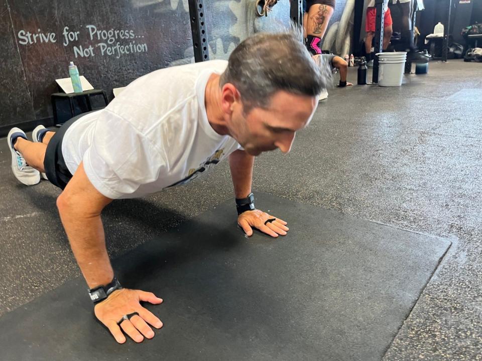 Ken Ausley does push-ups as part of the grueling “Murph” workout on Memorial Day at Zone Health and Fitness.