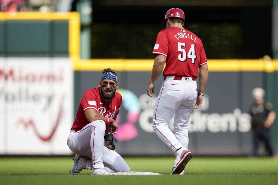 Cincinnati Reds' Nick Martini, center, left, reacts after Detroit Tigers second baseman Colt Keith caught him stealing second base in the second inning of a baseball game in Cincinnati, Saturday, July 6, 2024. (AP Photo/Jeff Dean)