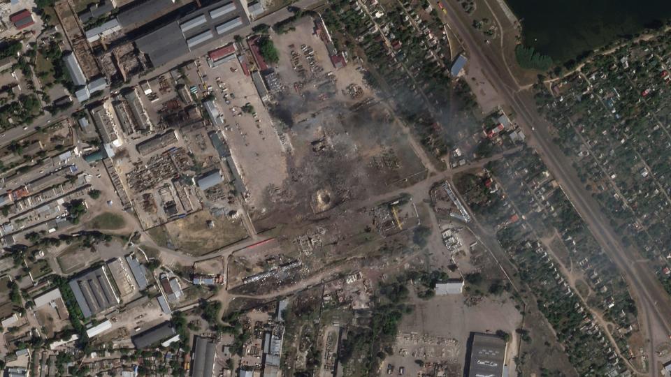 This satellite image from Planet Labs PBC shows the aftermath of a Ukrainian strike on a Russian ammunition depot in Nova Kakhovka, Ukraine, Tuesday, July 12, 2022. Ukrainian authorities said Tuesday that their forces targeted the Russian ammunition depot in southern Ukraine overnight, resulting in a massive explosion captured on social media. (Planet Labs PBC via AP)