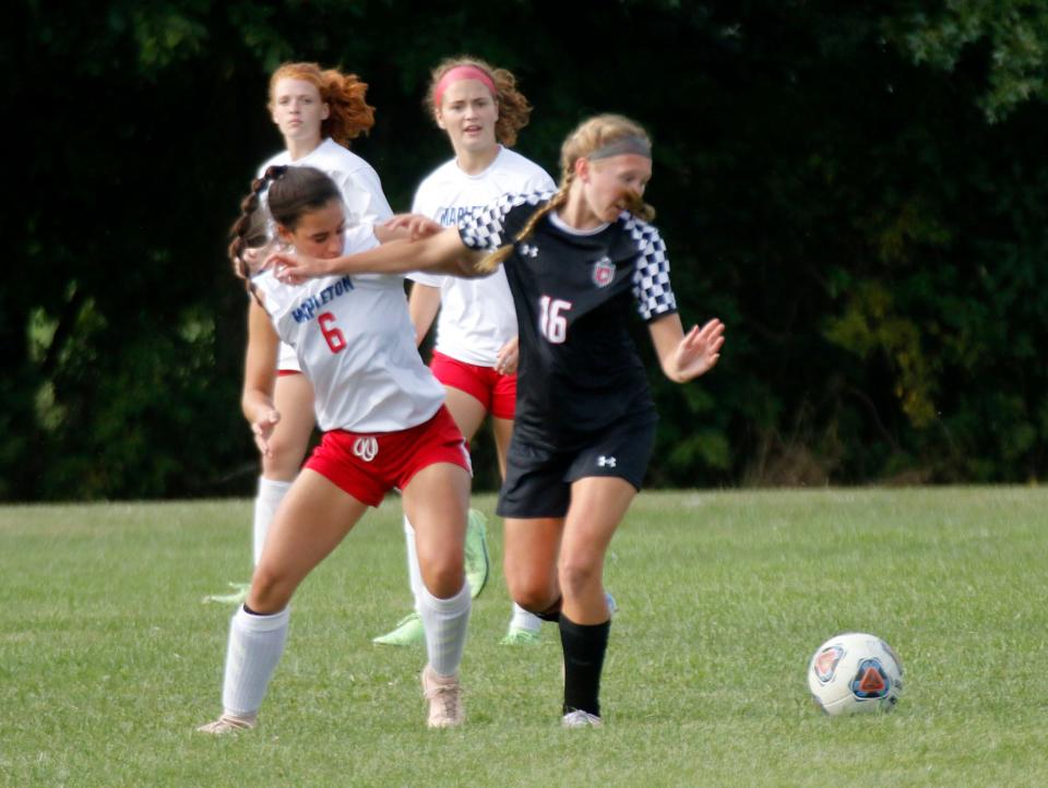 Mapleton High School's Jillian Carrick (6) and Crestview High School's Emma Aumend (16) battle to control the ball during high school girls soccer action Thursday, Sept. 9, 2021 at Crestview High School. TOM E. PUSKAR/TIMES-GAZETTE.COM