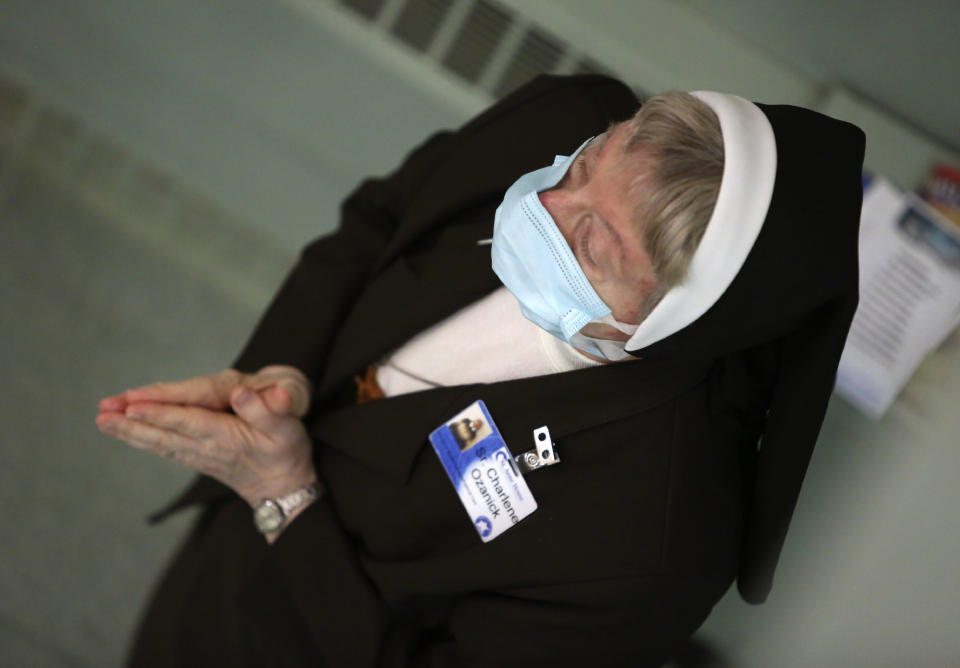 Sister Mary Charlene Ozanick, of the Felician Sisters of North America, prays during morning Mass at St. Anne Home in Greensburg, Pa., on Thursday, March 25, 2021. Communities of Catholic nuns are absorbing devastating losses from outbreaks of the coronavirus. The Felician Sisters lost 21 of their own, in four U.S. convents, a remarkable blow for a community of about 450 women. (AP Photo/Jessie Wardarski)