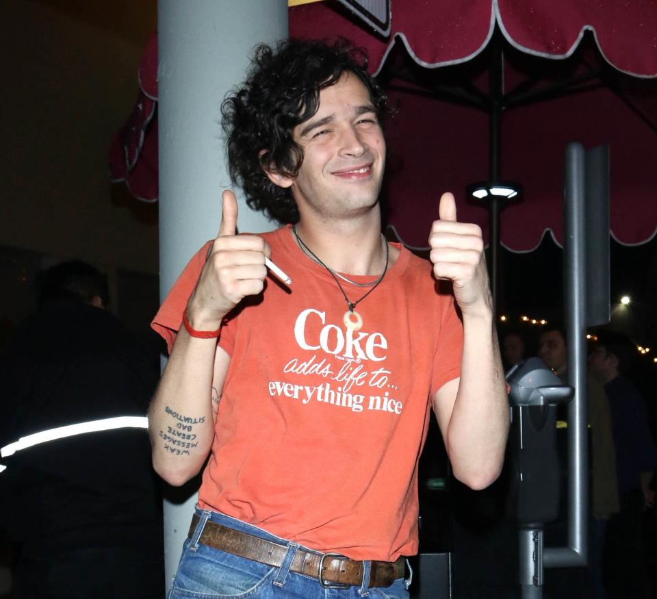 Closeup of Matty Healy giving two thumbs up