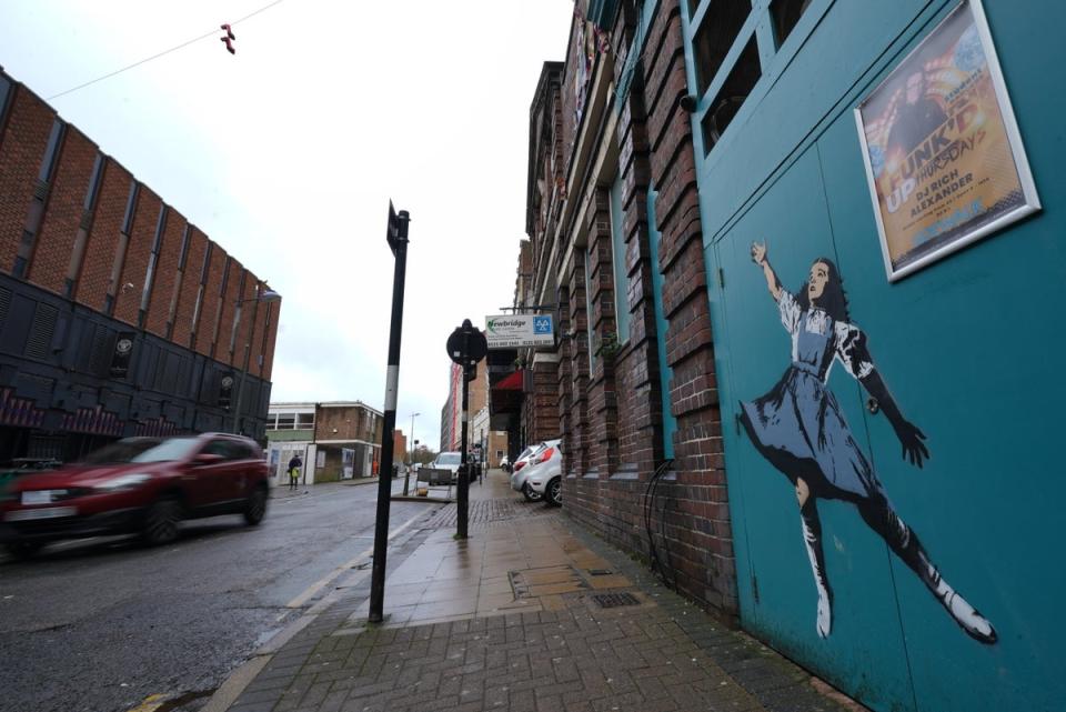 Dorothy reaching for the shoes in the artwork (Jacob King/PA Wire)