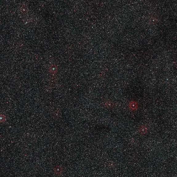 This wide-field image shows the patch of sky around the distant active galaxy PKS 1830-211. This view was created from photographs forming part of the Digitized Sky Survey 2. Image released Oct. 16, 2013.