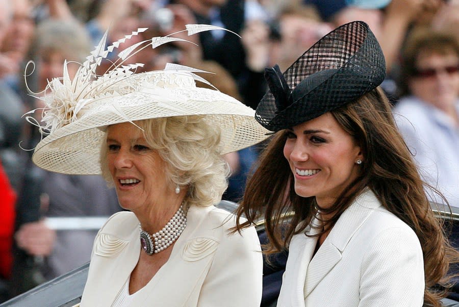 FILE – Britain’s Duchess of Cambridge, right, and Camilla, Duchess of Cornwall, leave Buckingham Palace in a open horse drawn carriage on their way to the Horse Guards Parade for the Trooping the Colour ceremony to mark the official birthday of the Queen, in London, Saturday, June 11, 2011. (AP Photo/Akira Suemori, File)