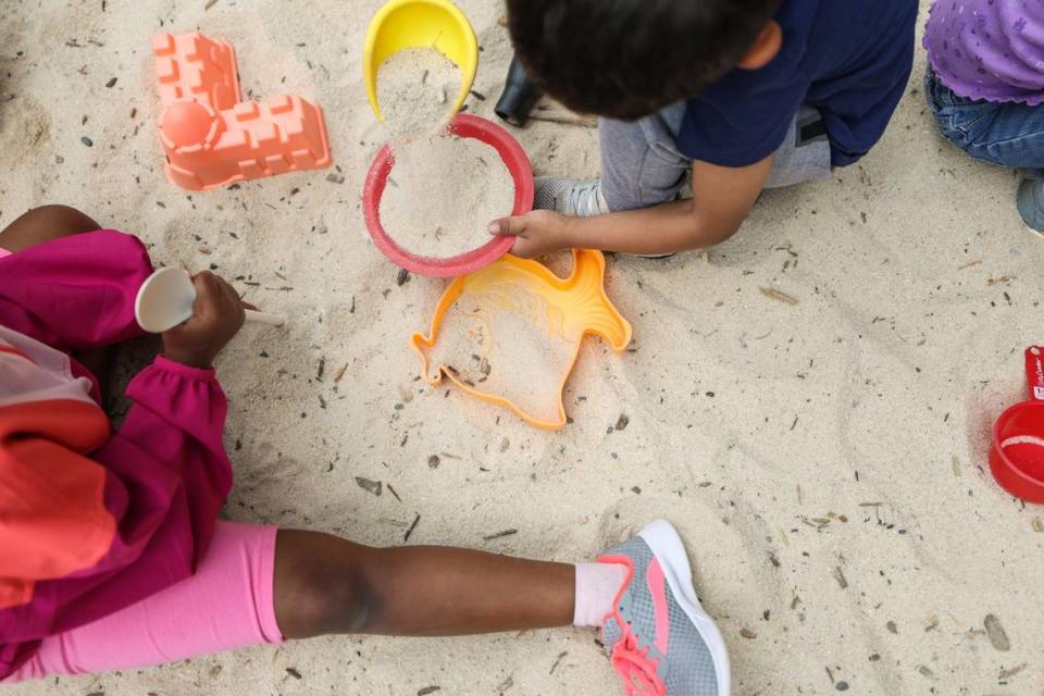 Kids enjoy the playground of Lollipops daycare center during outdoor time on Monday, April 10, 2023.