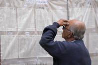 A man looks for his polling post during presidential elections in Bogota, Colombia, Sunday, May 29, 2022. (AP Photo/Fernando Vergara)