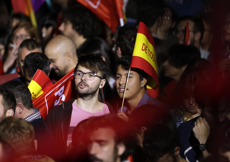 Supporters of Spanish Prime Minister and Socialist Party candidate Pedro Sanchez gather at the party headquarters waiting for results of the general election in Madrid, Sunday, April 28, 2019. Spain's governing Socialists won the country's national election Sunday but will need the backing of smaller parties to stay in power, while a far-right party rode a groundswell of support to enter the lower house of parliament for the first time in four decades, provisional results showed. At left is his wife Maria Begona Gomez. (AP Photo/Andrea Comas)
