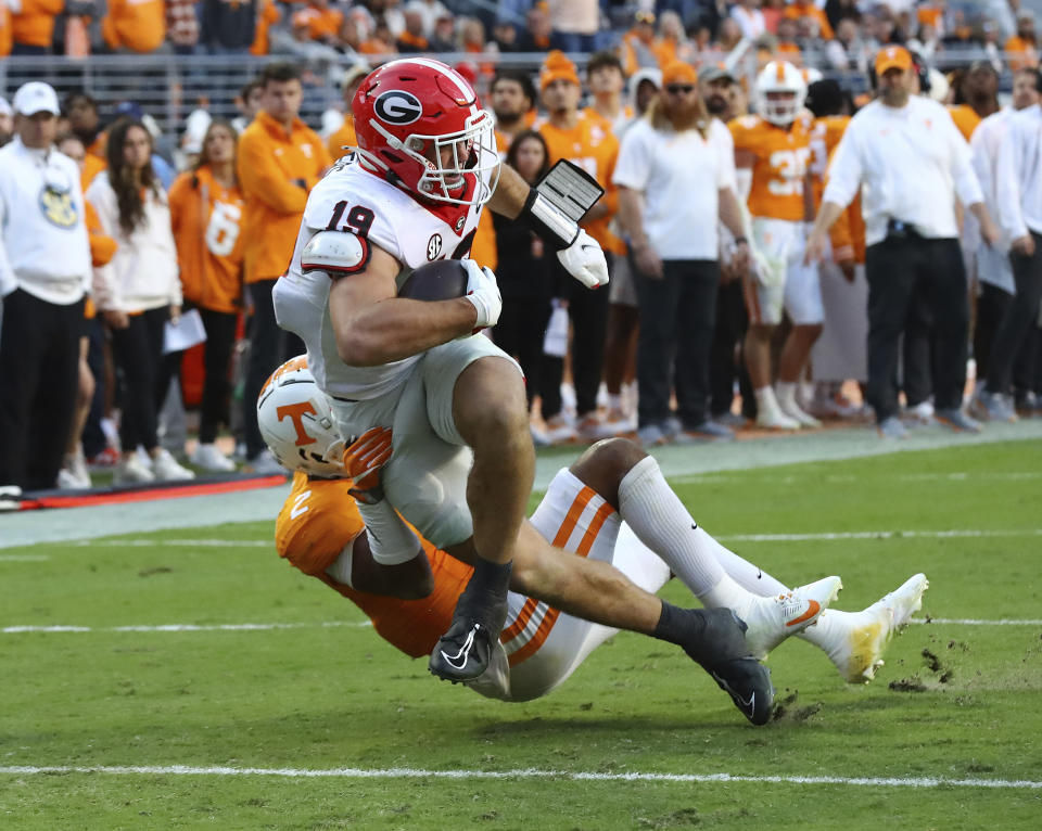 Georgia tight end Brock Bowers powers his way into the end zone past Tennessee defensive back Jaylen McCollough during the second quarter of an NCAA college football game, Saturday, Nov. 18, 2023, in Knoxville, Tenn. (Curtis Compton/Atlanta Journal-Constitution via AP)