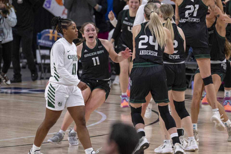 Green Bay guard Natalie McNeal (11), second from left, races onto the court as the team celebrates defeating Cleveland State in the championship game of the women's NCAA college basketball Horizon League Conference Tuesday, March 12, 2024, in Indianapolis. McNeal scored a career-high 32 points to go with eight rebounds and No. 2 seed Green Bay took down No. 1 seed Cleveland State 64-40. (AP Photo/Doug McSchooler)