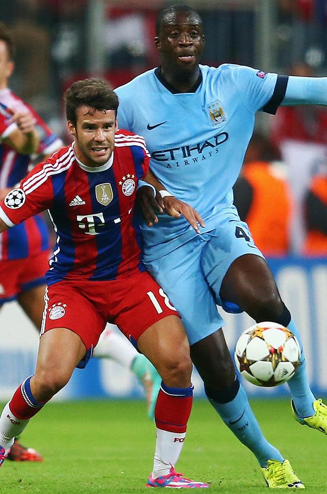 Juan Bernat tangles with Yaya Touré in a Champions League game in 2014