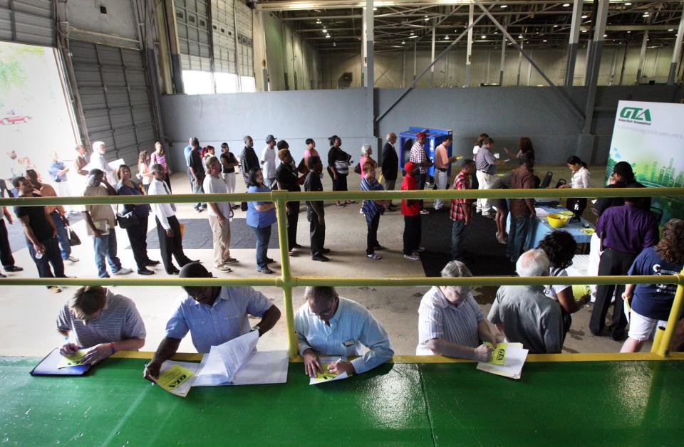 In this July 10, 2012, photo, job seekers attend a career fair hosted by GreenTech Automotive in Horn Lake, Miss. The number of people seeking unemployment benefits plunged last week to the lowest level in four years, a hopeful sign for the struggling job market. But the decline was partly due to temporary factors. (AP Photo/The Commercial Appeal, Mike Maple)