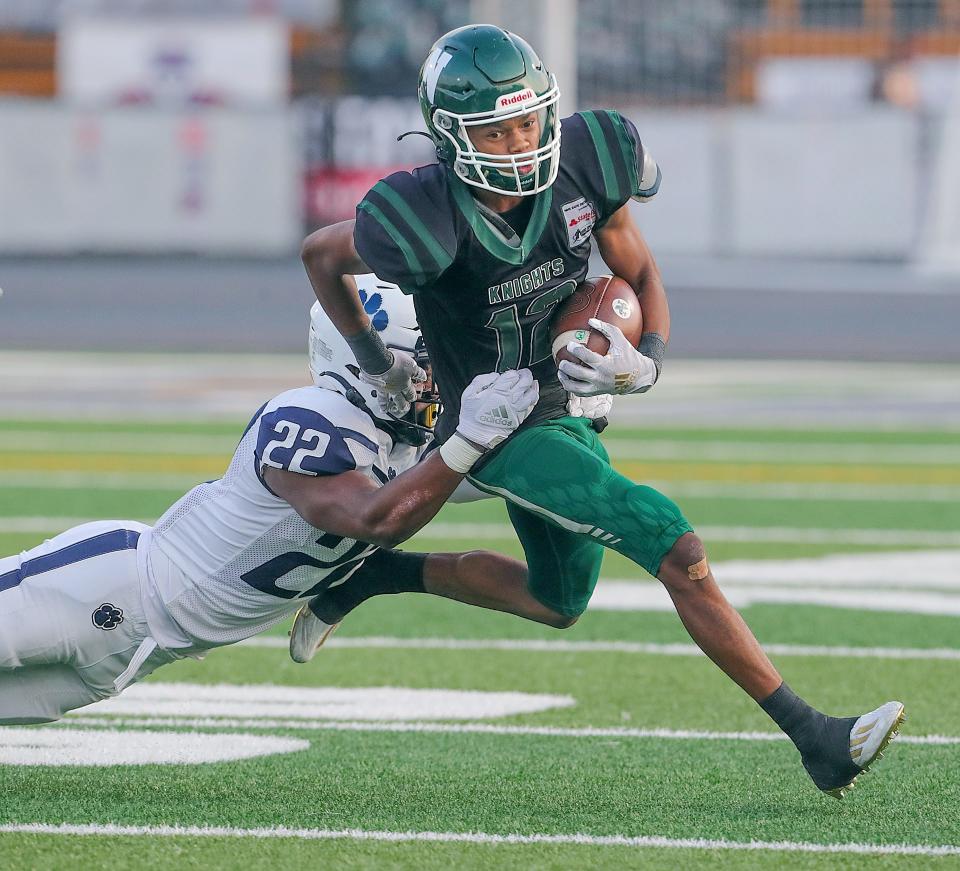 Nordonia receiver Israel Petite is caught from behind by Twinsburg's Quincy Newsom on Sept. 16, 2022, in Macedonia.