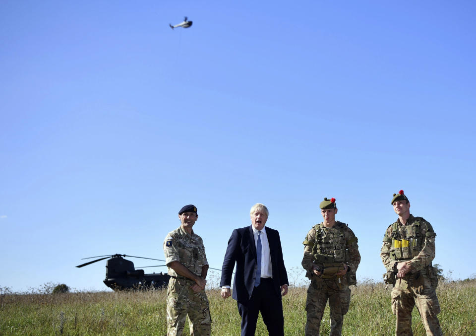 Britain's Prime Minister Boris Johnson flies a Black Hornet nano drone as he meets with military personnel on Salisbury Plain training area near Salisbury, England, Thursday, Sept. 19, 2019. British Prime Minister Boris Johnson was accused by a one of the country’s former leaders of a “conspicuous” failure to explain why he suspended Parliament for five weeks, as a landmark Brexit case at the U.K. Supreme Court came to a head on Thursday. (Ben Stansall/Pool Photo via AP)