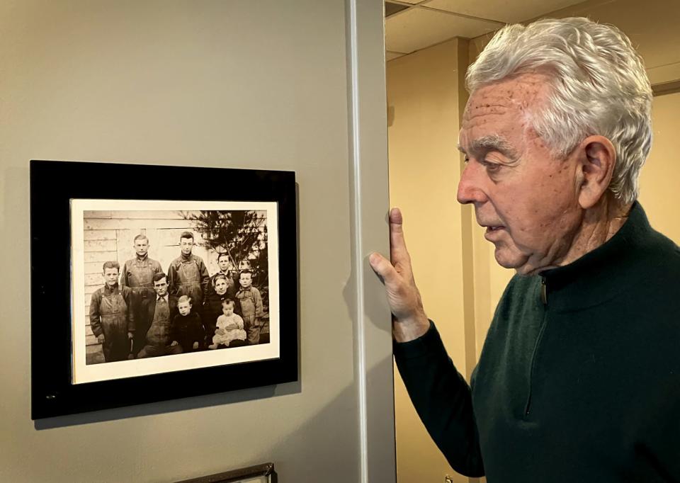 Grosse Pointe attorney S. Gary Spicer, 81, whose clients have included Ernie Harwell and Tigers legend Kirk Gibson, stands beside family photos outside his law firm.