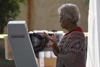 A woman casts her ballot during the local state elections in Cuautitlán Izcalli, Mexico state, Mexico, Sunday, June 4, 2023. (AP Photo/Marco Ugarte)