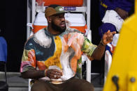 Los Angeles Lakers' LeBron James watches from the bench during the first half of an NBA basketball game between the Lakers and the Utah Jazz Saturday, April 17, 2021, in Los Angeles. (AP Photo/Mark J. Terrill)
