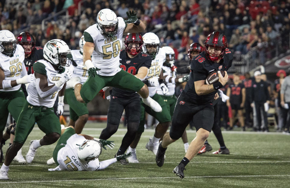 Western Kentucky quarterback Austin Reed (16) runs the ball for a touchdown against UAB during an NCAA college football game, at E. A. Diddle Arena in Bowling Green, Ky., on Friday, Oct. 21, 2022. (Grace Ramey/Daily News via AP)