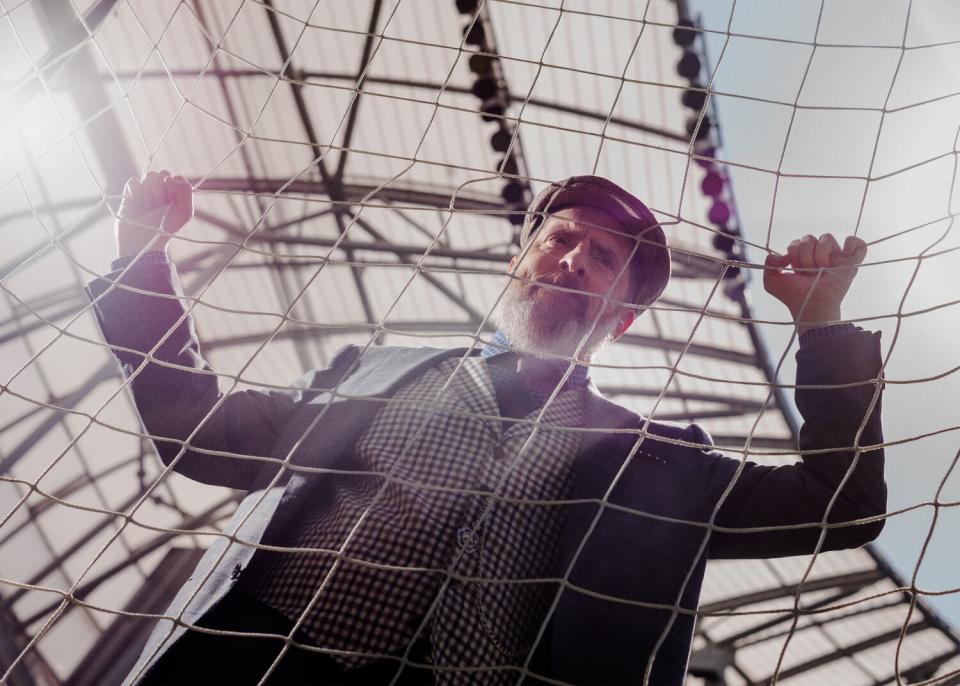 Brendan Hunt clings to the goal net at BMO Stadium for a portrait.