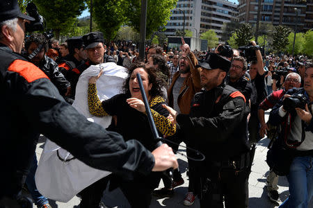 A protester breaks through a police line after a nine-year sentence was given to five men accused of the multiple rape of a woman during Pamplona's San Fermin festival in 2016, in Pamplona, Spain, April 26, 2018. REUTERS/Vincent West