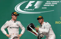 Formula One F1 - U.S. Grand Prix - Circuit of the Americas, Austin, Texas, U.S., 23/10/16. Mercedes' Lewis Hamilton of Britain raises his victory trophy as second placed finisher and teammate Nico Rosberg (L) of Germany looks on during the victory ceremony. REUTERS/Adrees Latif