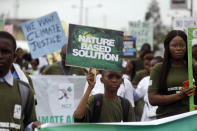 Protesters march to demand action on climate change, on the streets in Lagos, Nigeria Friday, Nov. 29, 2019. Protesters around the world joined rallies on Friday as a day of worldwide demonstrations calling for action against climate change. (AP Photo/Sunday Alamba)