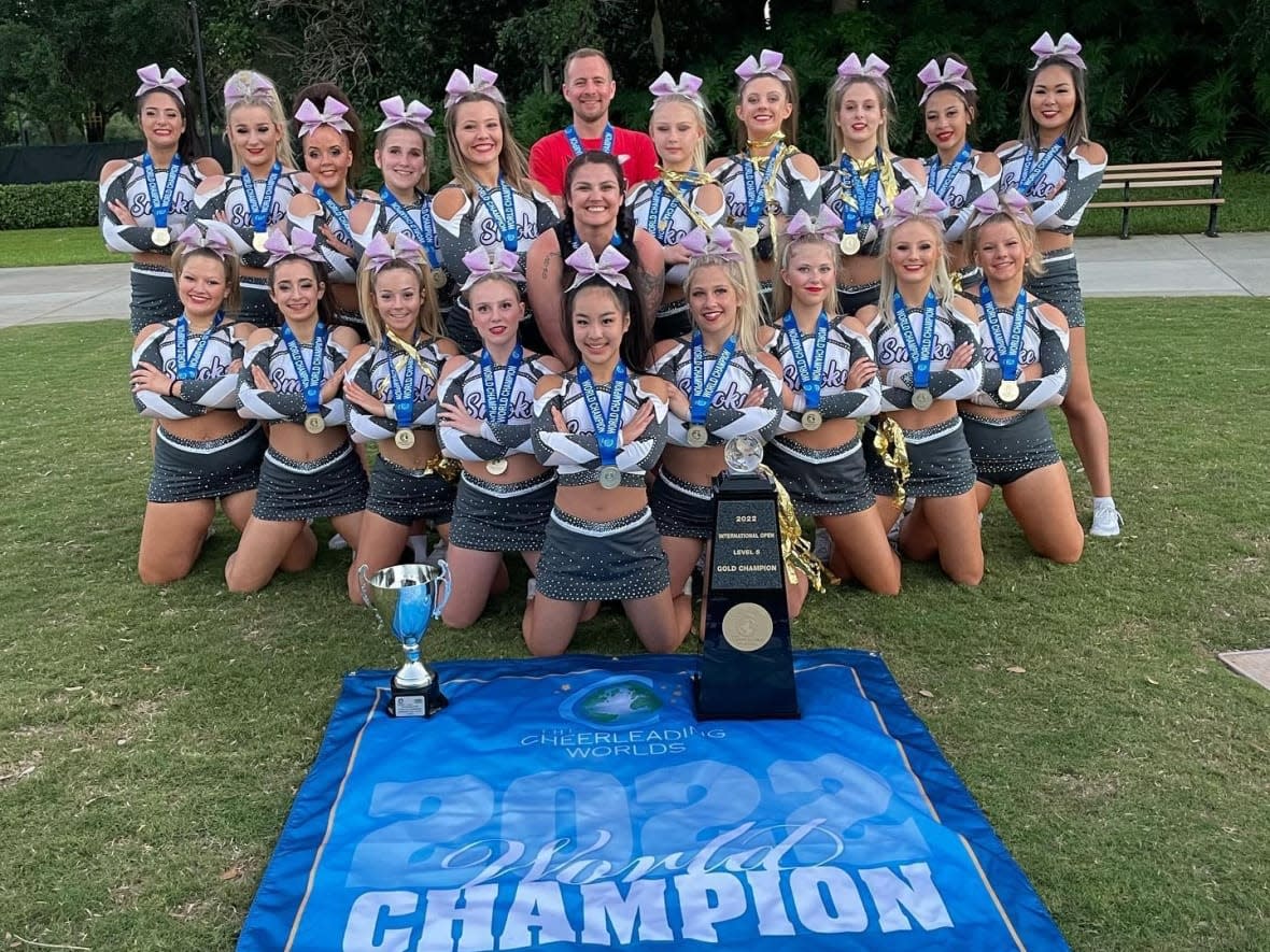 Members of the Rebels Cheerleading Athletics’ (RCA) team Smoke pose for a picture after winning a gold medal at the Cheerleading Worlds tournament in Orlando, Fla. (Submitted by Saskatchewan Cheerleading Association - image credit)
