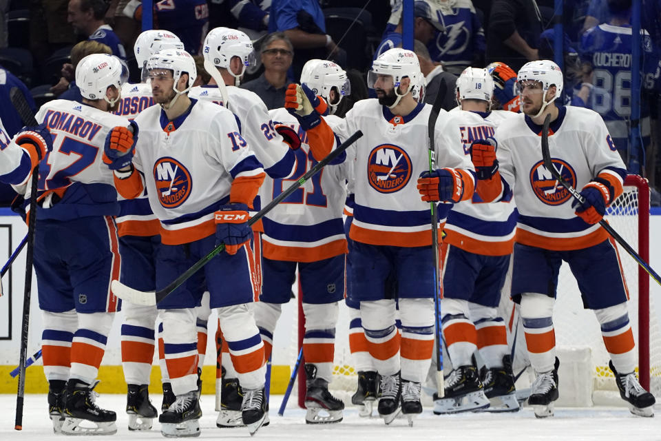 New York Islanders players celebrate after defeating the Tampa Bay Lightning during Game 1 of an NHL hockey Stanley Cup semifinal playoff series Sunday, June 13, 2021, in Tampa, Fla. (AP Photo/Chris O'Meara)