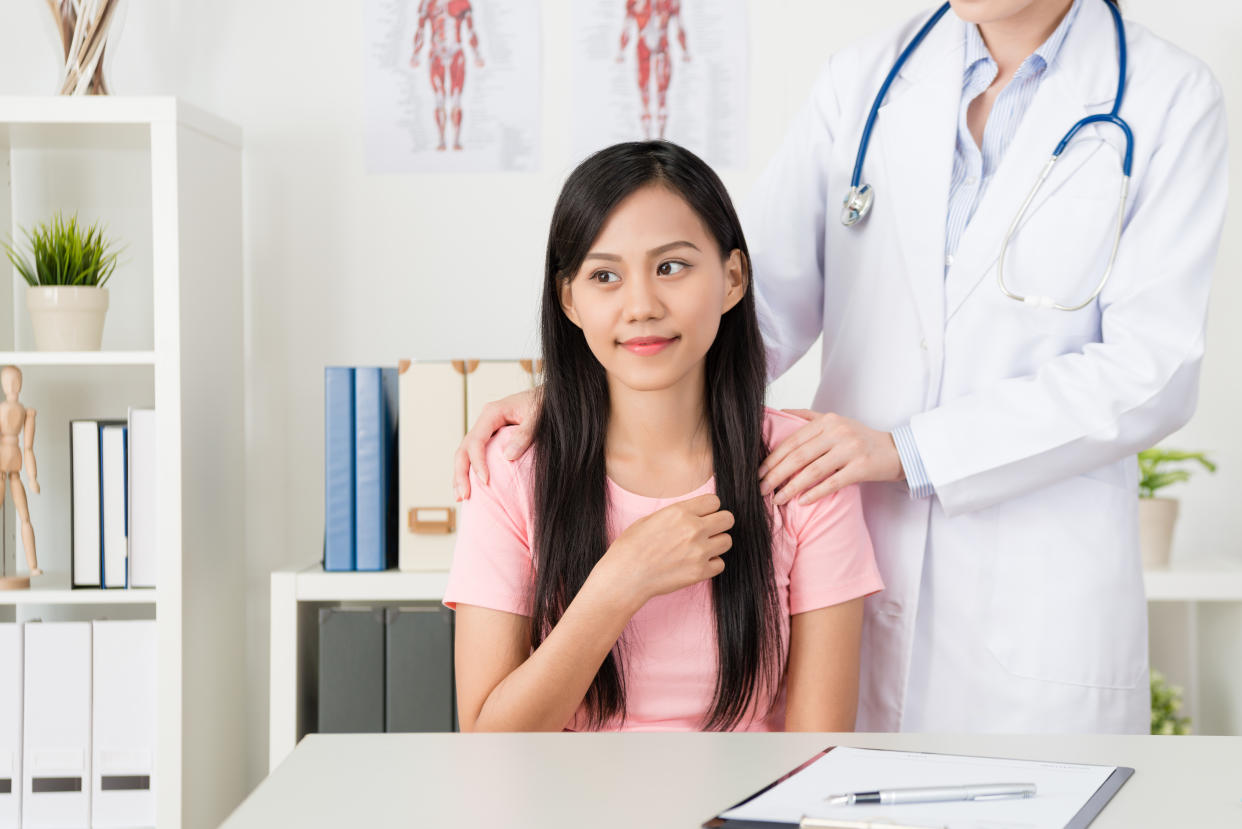 smiling pretty female patient feeling warmth when doctor concern her.